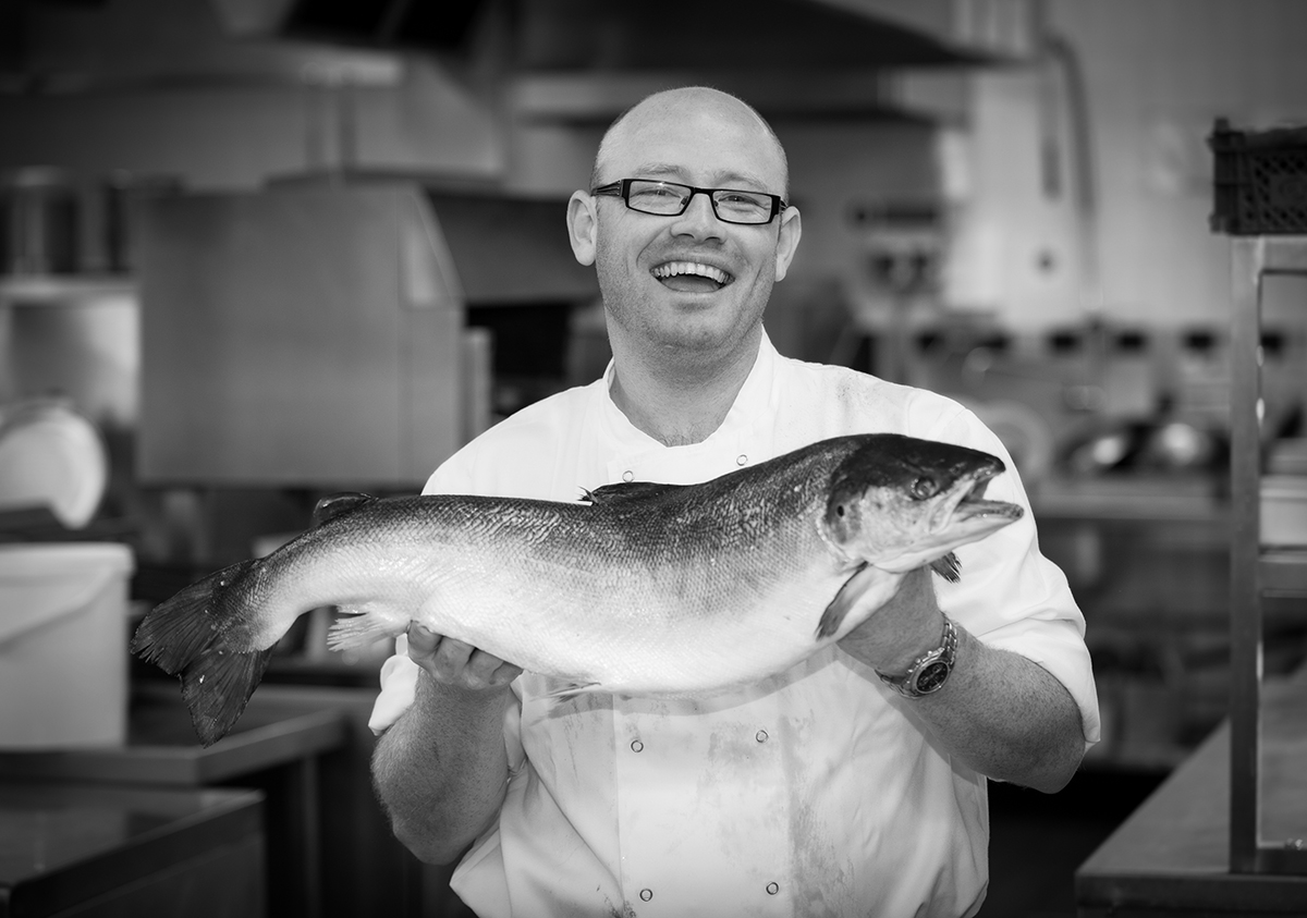 BW shot of a chef with a large fish